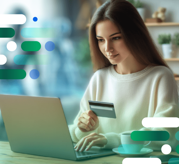 Person using a laptop while holding a credit card, emphasizing real-time analytics for continuous intelligence and rapid anomaly detection.
